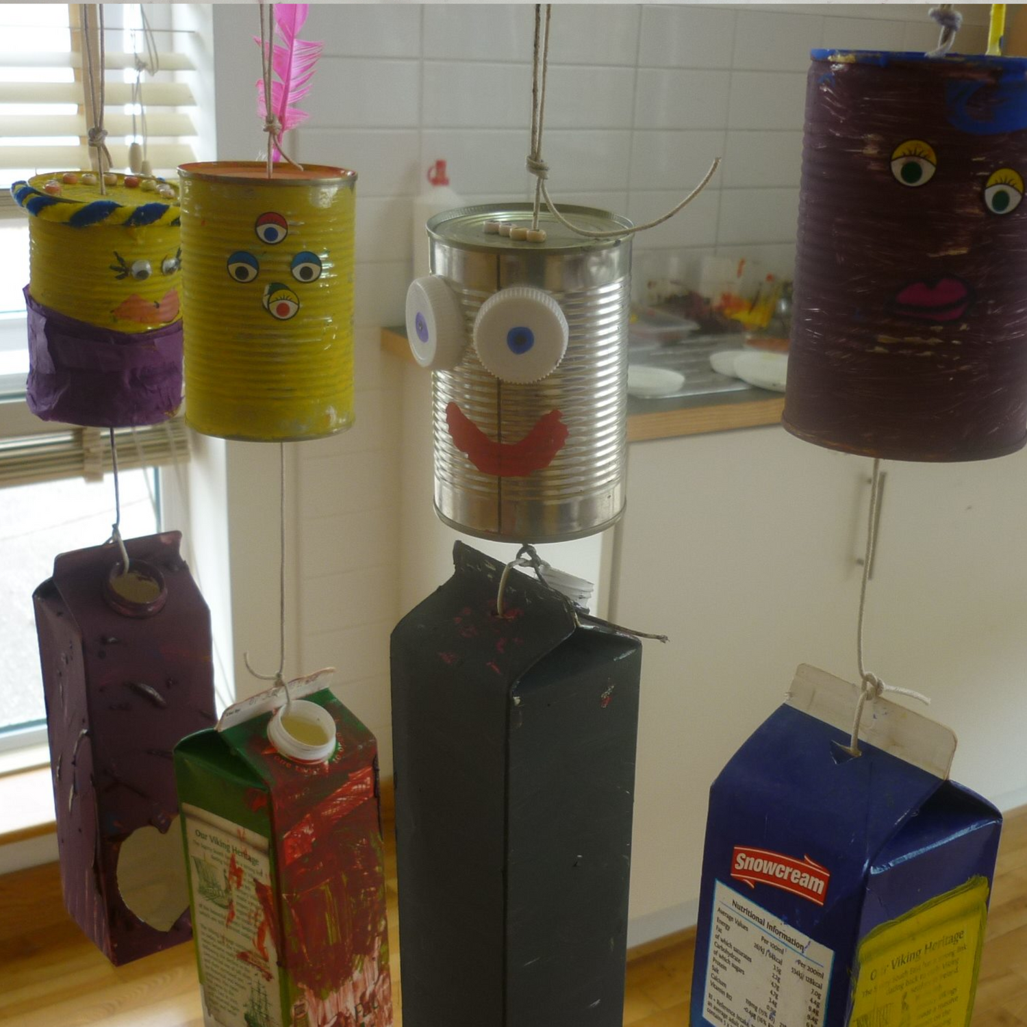 old cans and cartons painted and used to make fun characters during a Reduce Reuse Recycle Workshop